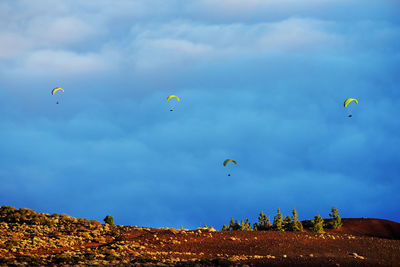 People paragliding over el teide national park