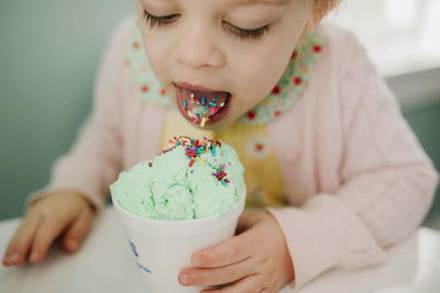 Girl eating ice cream with sprinkles