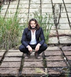 Portrait of young man sitting outdoors