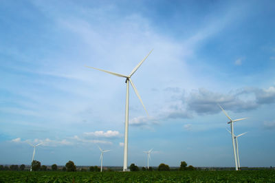 Windmill on field against sky