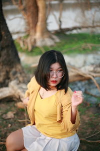 Portrait of young woman sitting outdoors