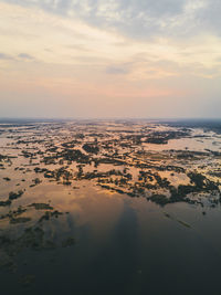 Aerial view of sea against sky during sunset