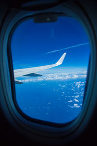 Aerial view of sea seen through airplane window