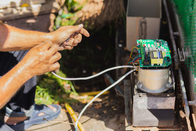 Technician man installing automatic electronic gate in the house.