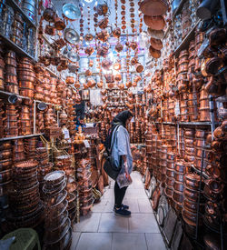 Rear view of woman standing at market stall