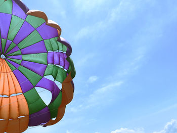 Low angle view of parachute against blue sky