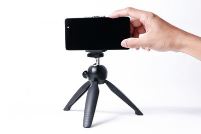 Low angle view of person photographing against white background