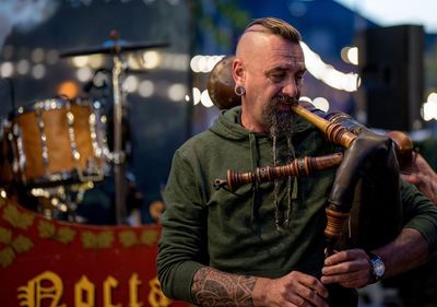 Musician playing wind instrument at concert