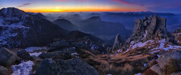 Scenic view of mountain against cloudy sky during sunset