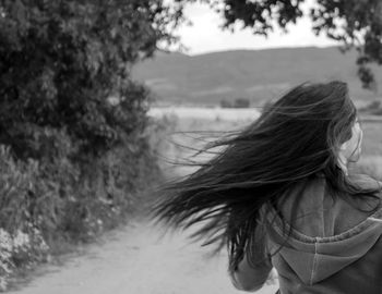 Rear view of a woman walking on landscape