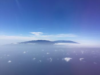 Scenic view of mountains against blue sky