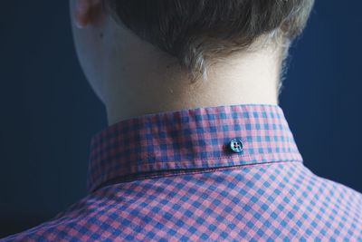 Rear view of man wearing checked shirt