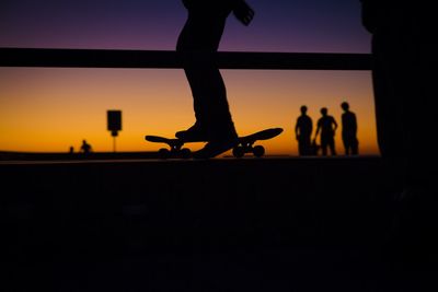 Silhouette people against clear sky during sunset