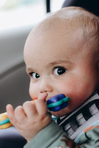 Sweet little baby boy in the car in baby safety seat