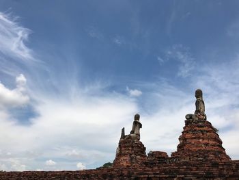 Low angle view of statue against cloudy sky