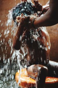 Woman bathing son in bathroom