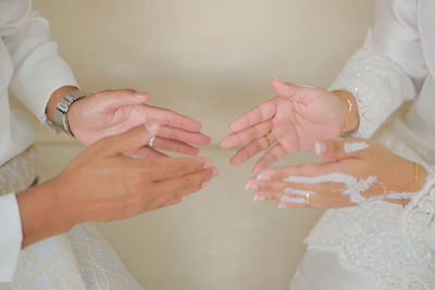 Midsection of bride with hands