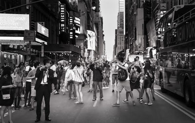 People on street in city during celebration