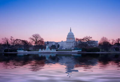 Reflection of building in lake at sunset