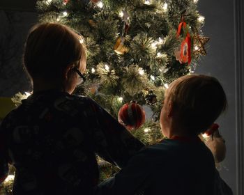 Rear view of a girl with christmas tree