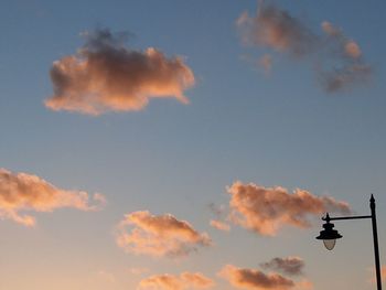 Low angle view of silhouette airplane against sky during sunset