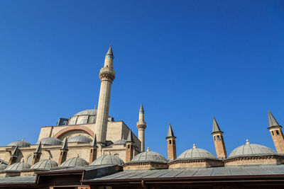 Low angle view of mosque against clear blue sky