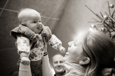 Portrait of happy mother holding baby