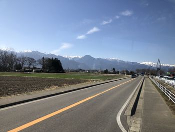 Road by mountain against sky