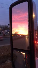 Cars on road at sunset