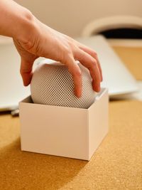 Close-up of man holding homepod mini