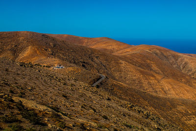 Scenic view of mountains against clear blue sky