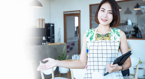 Portrait of a smiling young woman using smart phone