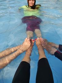 Low section of woman in swimming pool