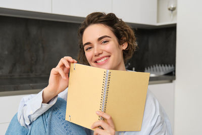 Portrait of young woman reading book