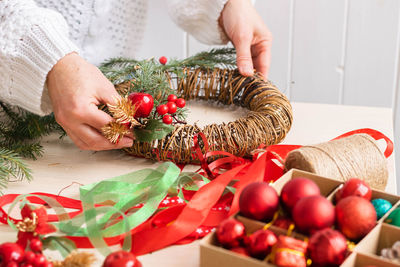 Midsection of woman holding christmas tree