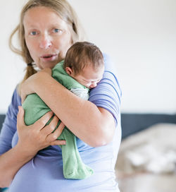 Portrait of grandmother with baby at home