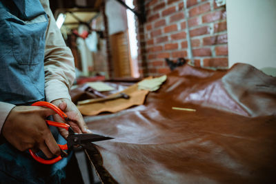 Midsection of man working at workshop