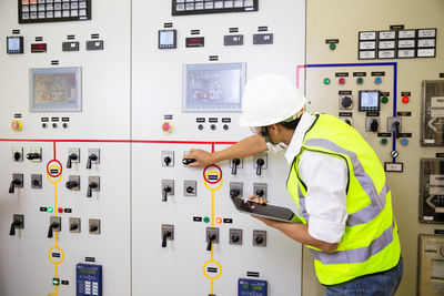 Electrician engineer work at relay protection system. bay control unit. medium voltage switchgear.
