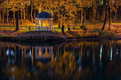 Small rothonda in autumn night park near water