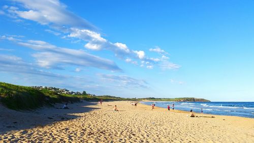 Scenic view of beach against blue sky