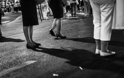 Low section of people standing on road