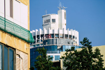 Low angle view of buildings against clear blue sky