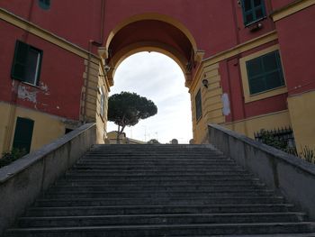 Low angle view of stairs along buildings