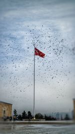 Scenic view of flag against sky