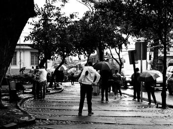 People walking on street in rain