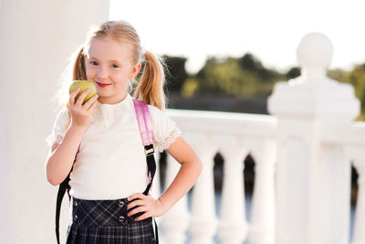 Portrait of cute girl eating apple