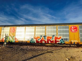 Graffiti on wall in city against sky