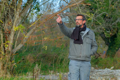 Full length of man standing in forest