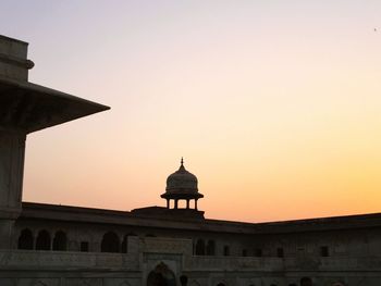 High section of built structure against clear sky at sunset