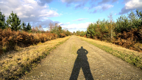 Shadow of man on road